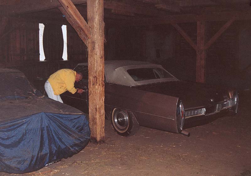 This is the collector with his car in the barn.