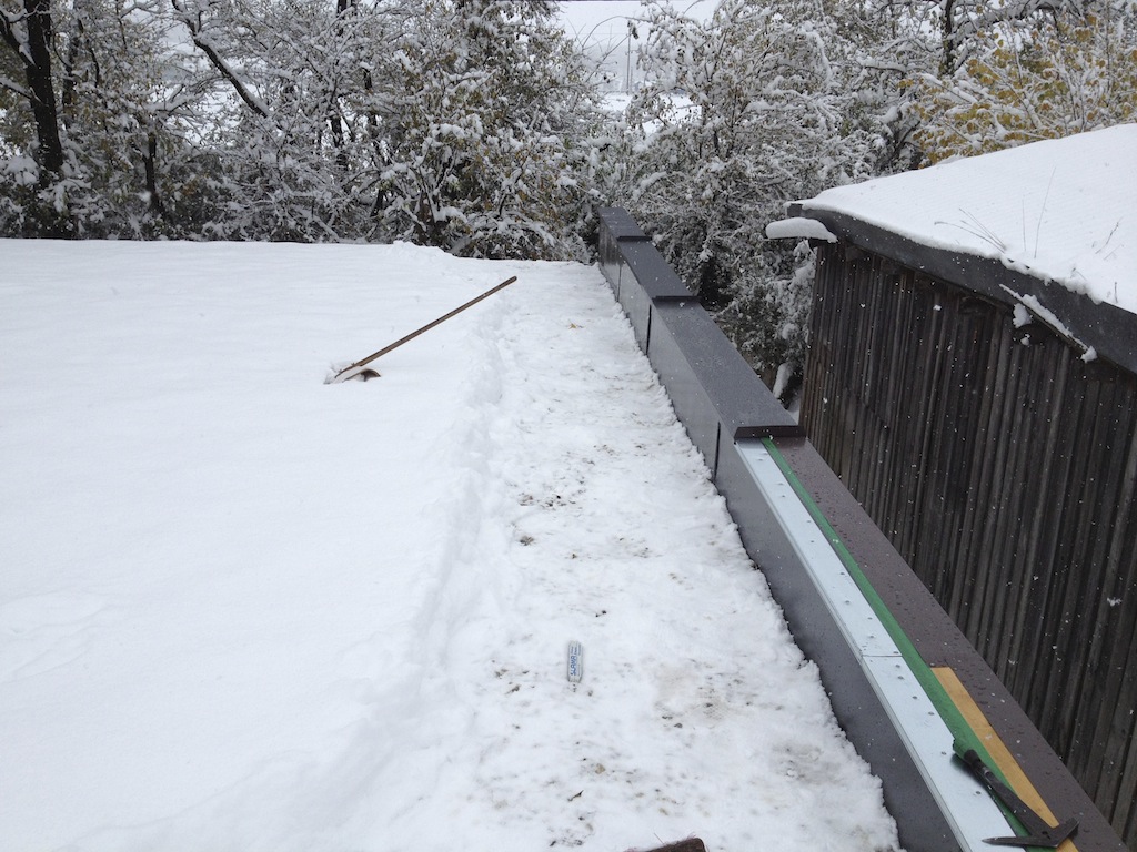 finishing touches on the roof in the snow