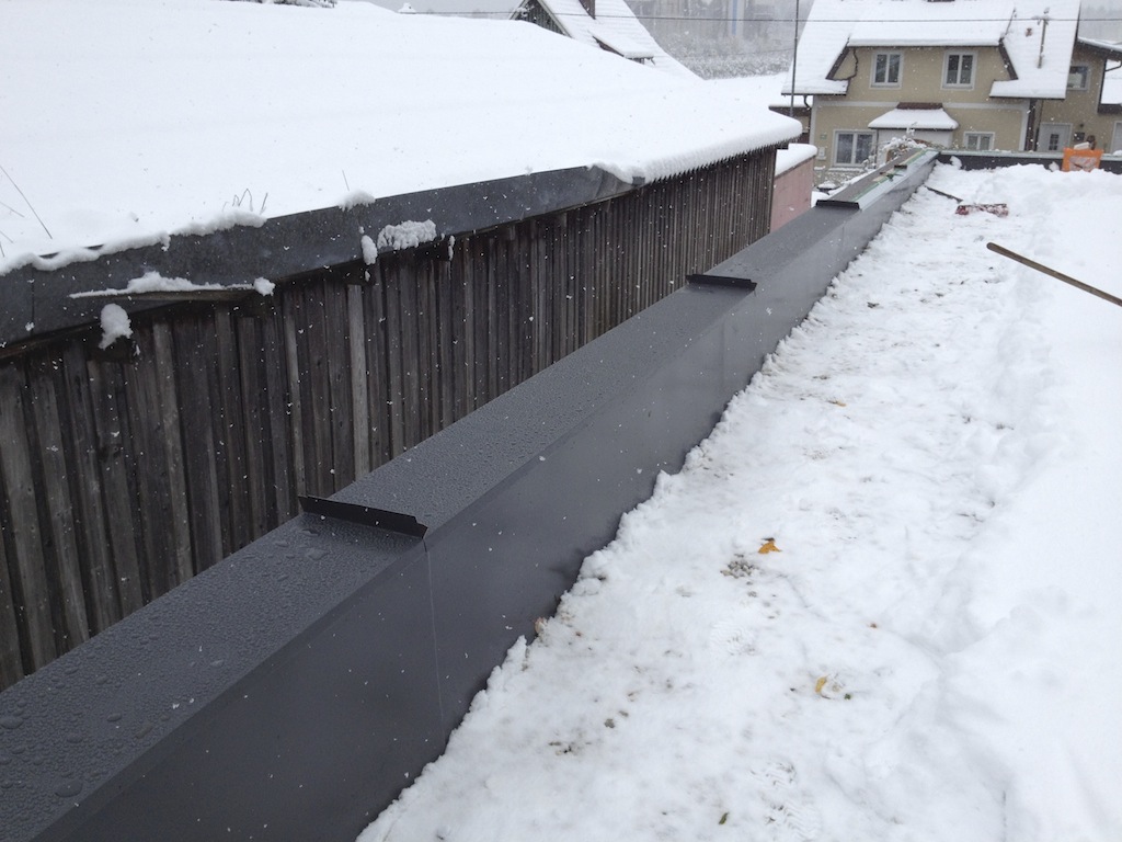 finishing touches on the roof in the snow