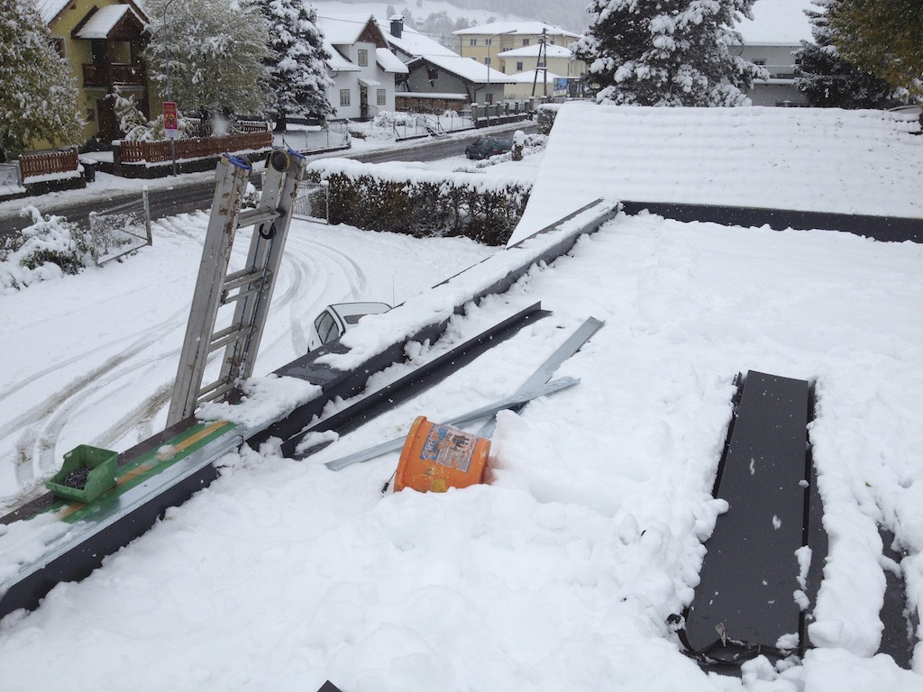 finishing touches on the roof in the snow